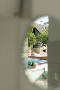 a view of a house through a magnifying glass at Almond Buna PoolHouse in Mostar +64 photos