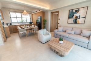 a living room with a couch and a table at Akres Luxury Sea View Villas in Psalidi