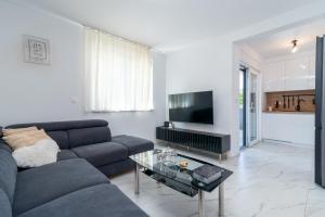 a living room with a couch and a table at Apartment Cvit in Trogir