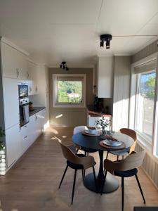 a kitchen and dining room with a table and chairs at 2 leiligheter med panoramautsikt in Bergen