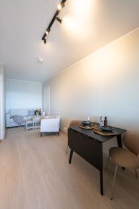 a living room with a table and a couch at Steam Apartments - Eidhøgda 6 in Tromsø +14 photos