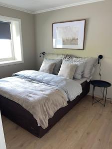 a bedroom with a large bed with pillows at 2 leiligheter med panoramautsikt in Bergen