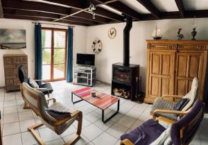 a living room with a fireplace and a stove at Villa 6 pers De Haan with warm swimming pool access in De Haan