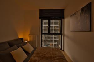 a living room with a couch and a window at Katowice Spodek in Katowice