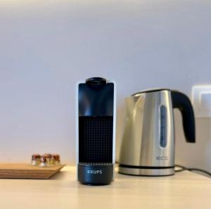 a coffee maker and a toaster sitting on a table at Conte Mykonos II in Aggelika