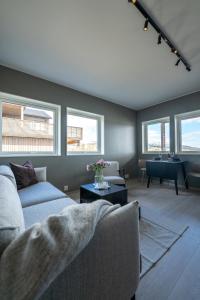a living room with a couch and a piano at Steam Apartments - Eidhøgda 6 in Tromsø