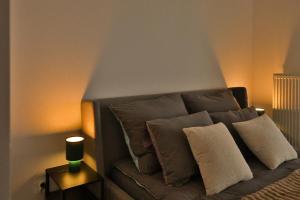 a couch with pillows and a candle on a table at Katowice Spodek in Katowice