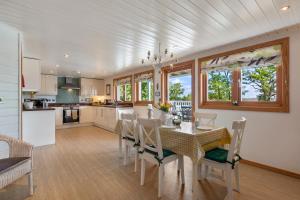 a kitchen and dining room with a table and chairs at The Bluebell - Luxury Lodge with Hot Tub in Penally