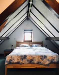 a bedroom with a large bed in a attic at Villa 6 pers De Haan with warm swimming pool access in De Haan