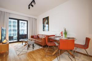 a living room with a table and a couch at Katowice Spodek 1-2-3 Pokojowy in Katowice