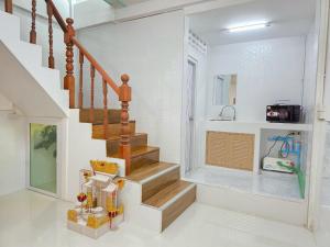 a staircase in a home with white walls at Nan Square II in Bangkok