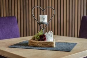 a table with a heart trophy on top of it at Hotel Bergkristall in Willingen