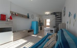 a living room with a bed and a kitchen at twins home in Castiglione della Pescaia