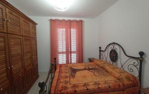 a bedroom with a bed and a red window at twins home in Castiglione della Pescaia