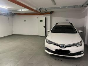 a white car is parked in a garage at City Center Luxury Apartments in Varna City +61 photos