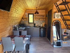Una cocina con mesa y sillas en una cabaña. en Heart of Mountains Escape, en Sioni