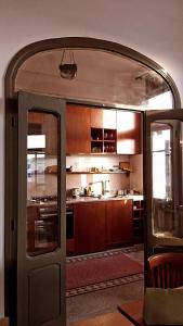 an open door to a kitchen with wooden cabinets at Tunis Montfleury in Tunis