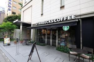 a starbucks coffee store on a city street at Richmond Hotel Tokyo Shiba in Tokyo