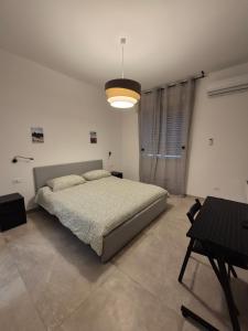A bed or beds in a room at Sicily Neapolis Apartment & Rooms
