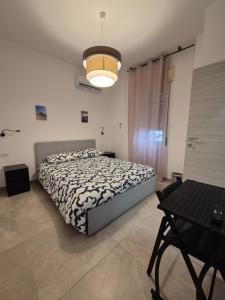 A bed or beds in a room at Sicily Neapolis Apartment & Rooms