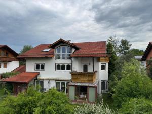 a large white house with a red roof at Villa am Goldbach in Bad Aibling