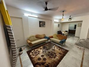 a living room with two couches and a table at Spacious 3 BHK Villa, Lonavala in Lonavala