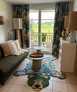 a living room with a couch and a teddy bear rug at Le terrier du Green appartement in Levernois +40 photos