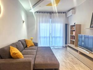 a living room with a couch and a television at Terrace between Rome and the sea in Vitinia