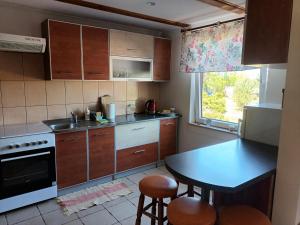 a small kitchen with a table and a sink at Bocianie Siedlisko in Janowo +10 photos