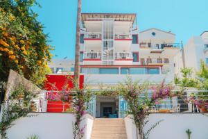 a building with stairs and flowers in front of it at Hotel No37 in Kaş