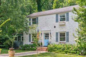 a white brick house with blue shutters at Large yard - Quiet area - 15 min to DC in Falls Church