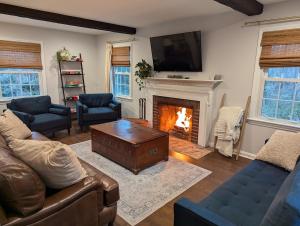 a living room with a couch and a fireplace at Large yard - Quiet area - 15 min to DC in Falls Church