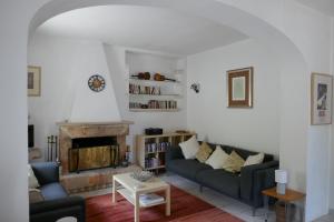 a living room with two couches and a fireplace at Monteviccoli in Ceglie Messapica