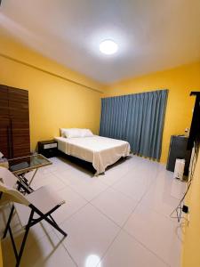 a bedroom with a bed and a table and chairs at Ｍing Shu Min Su in Linyuan