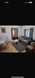 a living room with a couch and a table at Kuća za odmor Tupek in Zagreb