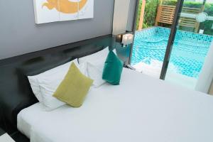 a bedroom with a bed and a swimming pool at Beachfront Family Pool 1 BR 1 Living Patong Phuket in Patong Beach