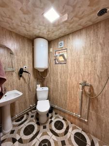 a bathroom with a toilet and a sink at Nizharadze's Tower in Ushguli +95 photos