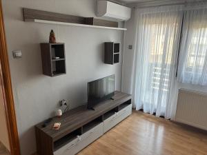 a living room with a flat screen tv on a wall at Apartman Bojan in Prnjavor