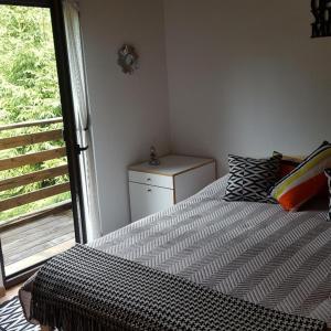 a bedroom with a large bed with a window at Forest-House in Praid