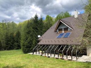 a house with solar panels on the roof at Forest-House in Praid