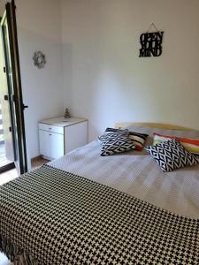 a bedroom with a large bed with pillows on it at Forest-House in Praid