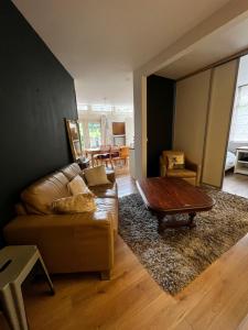 a living room with a couch and a coffee table at appartement op de begane grond met terrasje in Groesbeek