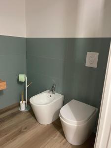 a bathroom with a white toilet and a sink at Donna Franca in Cinisi +9 photos