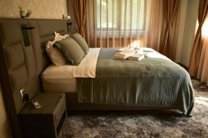 a bedroom with a bed with towels on it at Villa Vakanica in Petrich
