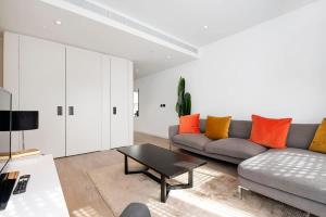 a living room with a couch and a coffee table at Modern 2 Bed Battersea Power Station in London