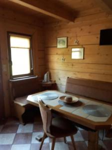 a wooden room with a table and chairs in a room at Domki z bali Polanica-Zdrój in Polanica-Zdrój