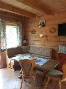 a room with a table and chairs in a cabin at Domki z bali Polanica-Zdrój in Polanica-Zdrój