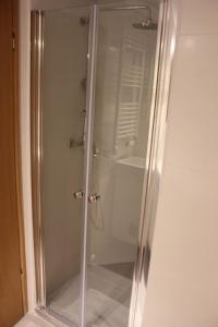 a shower with a glass door in a bathroom at Rooftop sea view apartment in Split +28 photos