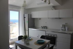 a kitchen with a table and a table and a window at Rooftop sea view apartment in Split