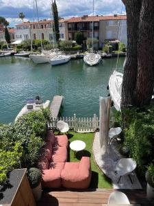 a view of a marina with boats in the water at Maison du Bonheur Newly renovated house, private garden and 12x4m mooring in Port Grimaud